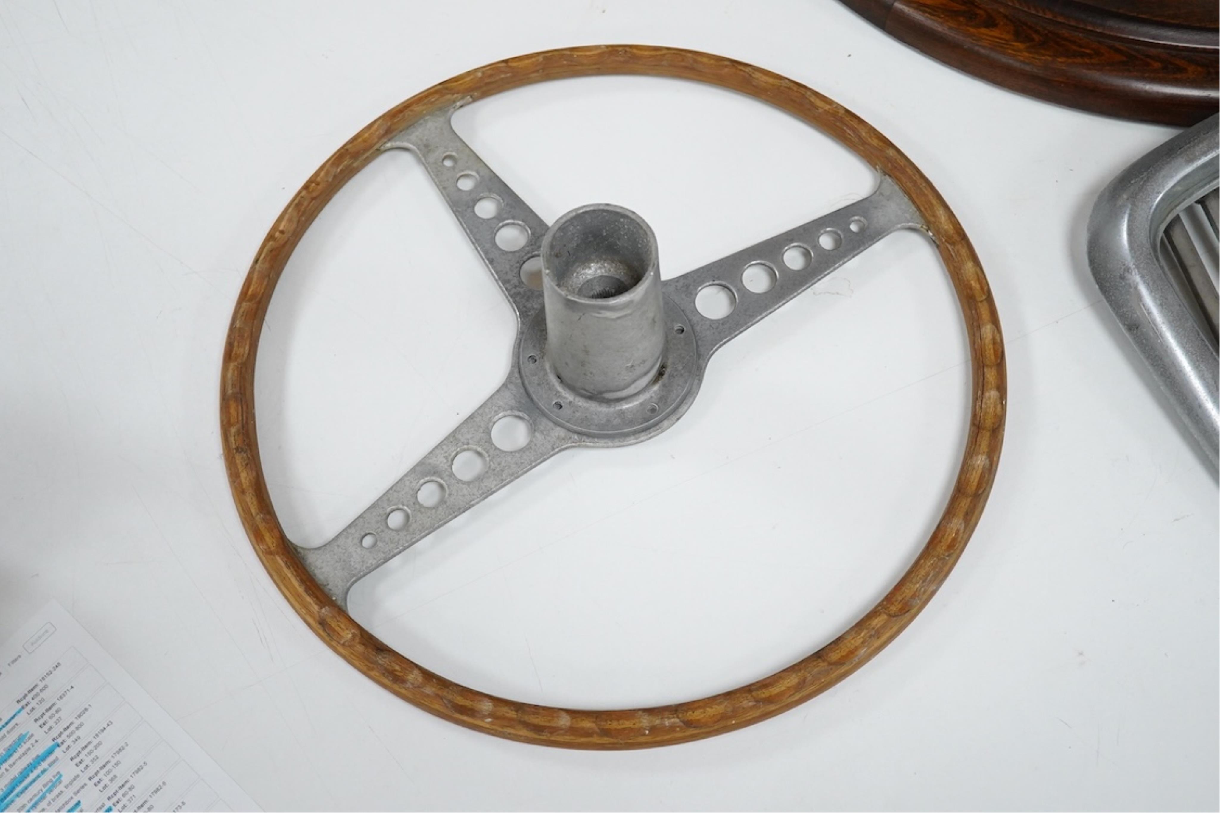 A Jaguar E Type steering wheel in wood and steel, together with the top section of the steering column which bolts to the steering wheel, missing the central Jaguar emblem, 41cm diameter